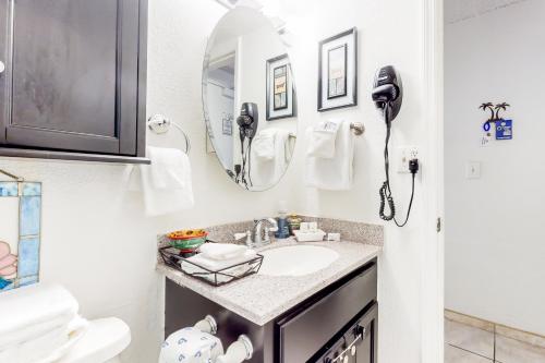 a bathroom with a sink and a phone at Harbour Beach Resort Unit 518 in Daytona Beach