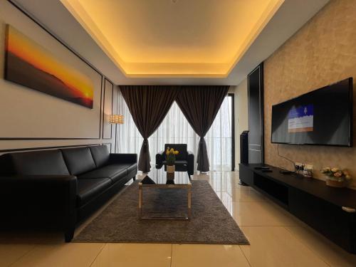 a living room with a couch and a tv at QUINCE HOME GRAND ION DELEMEN GENTING HIGHLANDs in Genting Highlands