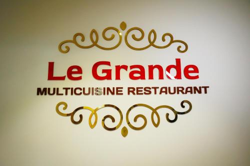 a red and gold logo with the words le granditate multipurpose restaurant at AJ GRAND ELITE HOTEL in Mangalore