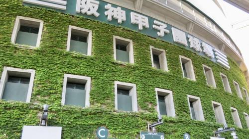 a green building with a sign on the side of it at Toyoko Inn Hanshin Amagasaki Ekimae in Amagasaki