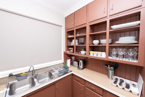 a kitchen with wooden cabinets and a sink at 29 in Corio