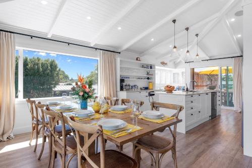 a kitchen and dining room with a table and chairs at Lakefront Style - Lake Taupo Holiday Home in Taupo