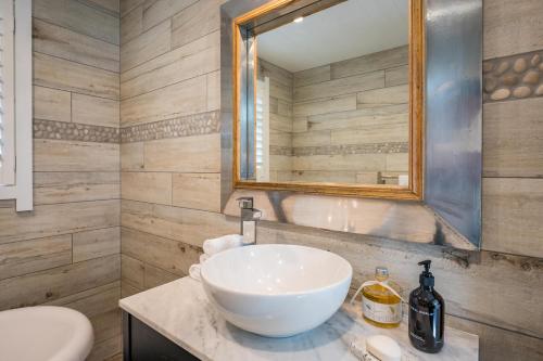 a bathroom with a white sink and a mirror at Lakefront Style - Lake Taupo Holiday Home in Taupo