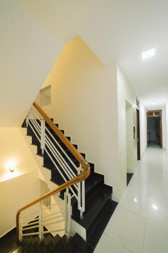 a staircase in a house with black and white floors at Mat Troi Vang Dalat Hotel in Da Lat