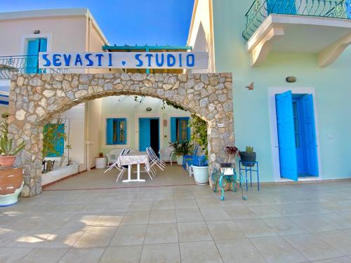 an archway in a building with a table and chairs at Sevasti Studios in Panormos Kalymnos