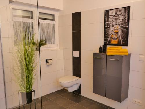 a bathroom with a toilet and a picture on the wall at Villa Kolberg in Gödersdorf