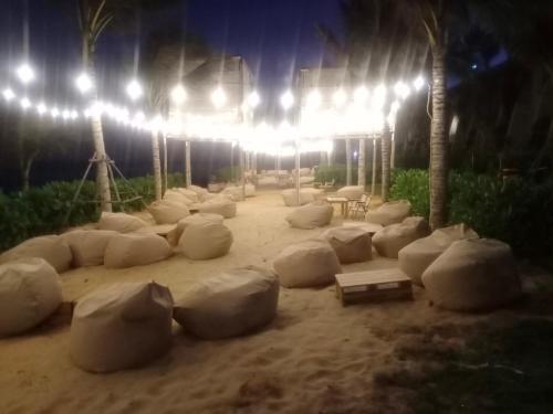 a group of white objects in the sand at night at APEC MANDALA Condotel in Phan Thiet