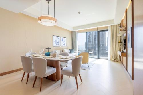 a dining room with a table and chairs at Address Opera Residences Burj Khalifa View in Dubai