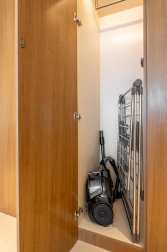 a small room with a treadmill in a closet at Address Opera Residences Burj Khalifa View in Dubai