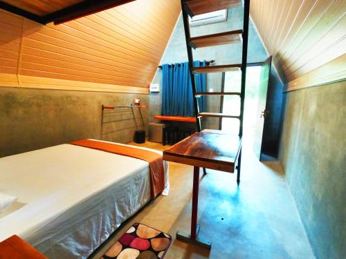 Säng eller sängar i ett rum på Ritigalafoothills