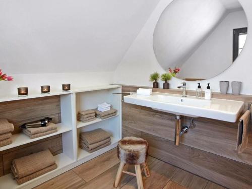 a bathroom with a sink and a mirror at La Maison Titisee Boutique Design in Titisee-Neustadt