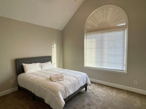 a bedroom with a bed and a large window at 2 Minute Walk To Gate 1 of Masters in Augusta