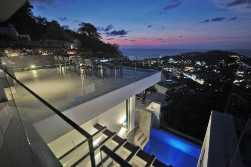 a house with a swimming pool at night at Villa Amonteera in Surin Beach