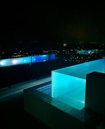 a night view of a building with blue lights at Villa Amonteera in Surin Beach
