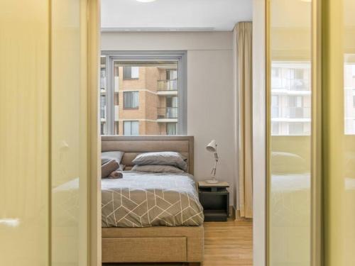 a bedroom with a bed and a window at City 3bd Oasis in Sydney
