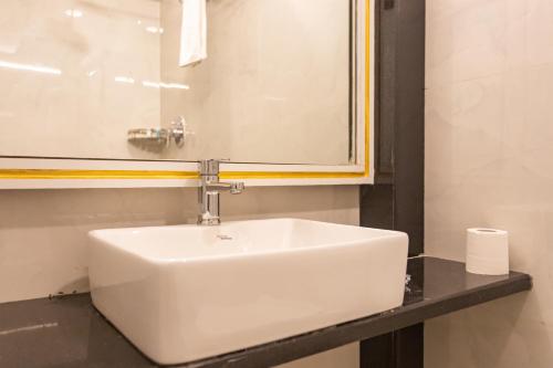 a white sink in a bathroom with a mirror at Aawas Boutique Hotel in Kathmandu