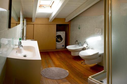 a bathroom with two sinks and a washing machine at Podere Brughee in Tremezzo