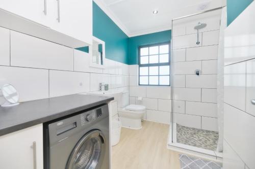 a laundry room with a washer and dryer at House 15 A Kassiesbaai in Arniston