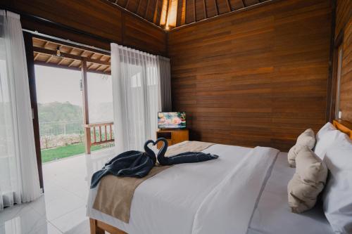 a bedroom with a bed with two towels on it at The Akasea Villa Bali in Ungasan