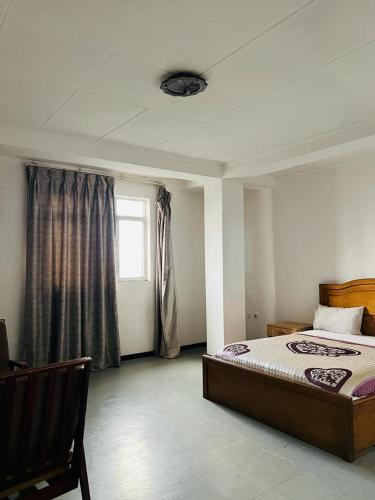 a bedroom with a bed and a window at Goza Guest House 22 in Addis Ababa