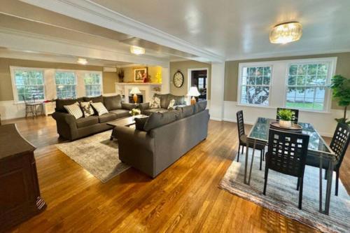 a living room with a couch and a table at The House Hotels - Acadia Farms in Northfield