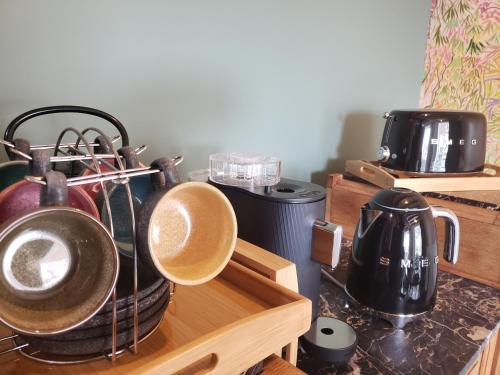a kitchen with pots and pans on a counter at L'ESTAMPE in Auvers-sur-Oise