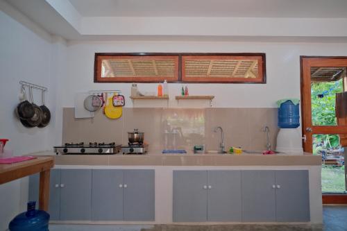 a kitchen with a sink and a counter top at Copacabana Siargao in General Luna