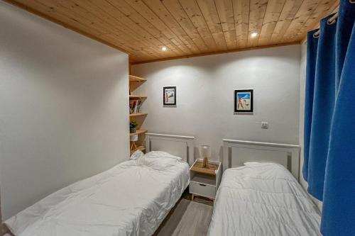 2 Betten in einem kleinen Zimmer mit in der Unterkunft CIEL MONTAGNARD - Apartment with mountain views in Annecy