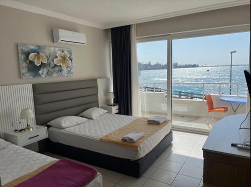 a bedroom with a bed and a view of the ocean at Side Beach Club in Side