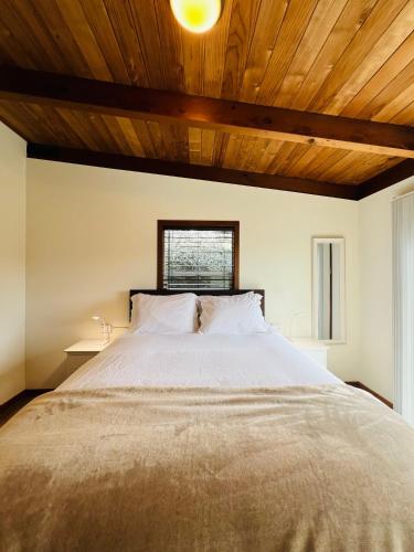 a bedroom with a large bed with a wooden ceiling at Pacific Sands Vacation Home by Vynmir in Fort Bragg