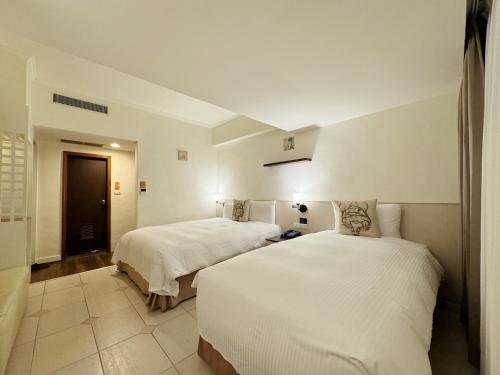 Postel nebo postele na pokoji v ubytování Finders Hotel Hualien Da-Tong