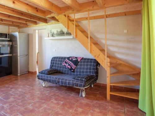 a living room with a couch under a stairs at Charming Villa in Poggio Mezzana Near Beach in Santa-Lucia-di-Moriani