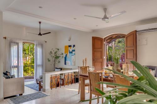 a living room with a table and chairs at Aguada Anchorage - The Villa Resort, Candolim in Candolim