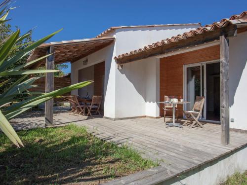 a patio of a house with a table and chairs at Charming Villa in Poggio Mezzana Near Beach in Santa-Lucia-di-Moriani