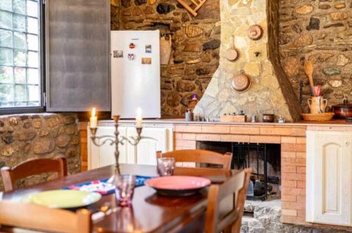 a kitchen with a wooden table and a refrigerator at La pace dei sensi in Maida