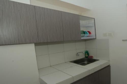 a kitchen with a sink and a counter top at Capital O 93730 Alima View Syariah in Bekasi