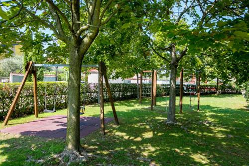 een leeg park met bomen en schommels bij Casa Kristall Lago - Happy Rentals in Desenzano del Garda