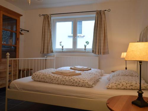 a bedroom with a bed with a window at A modern holiday home by the River Mosel in Moselkern