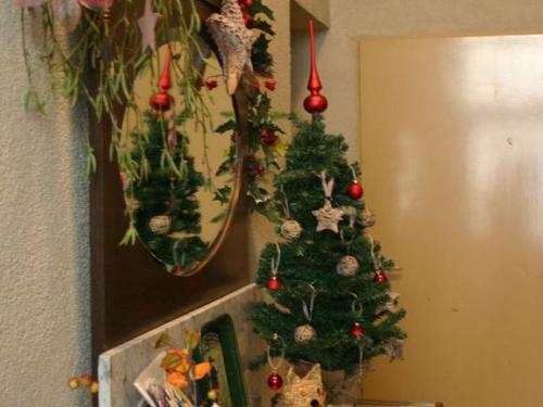 a christmas tree on the corner of a room at A modern holiday home by the River Mosel in Moselkern