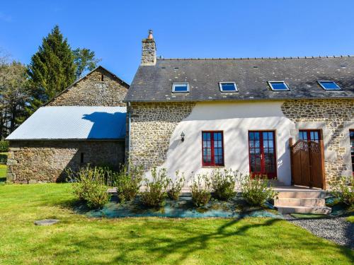 an old stone house with red windows and a roof at House with stunning views across the meadows in Bonnemain