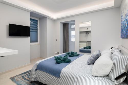 a bedroom with a bed with two plants on it at Modern & Stylish Apartment Close to Tigne Point - Close to Saint Julians & Valletta Ferry in Sliema