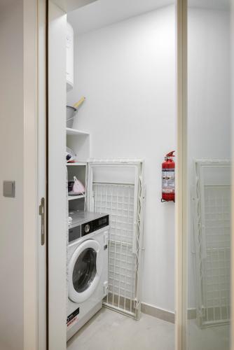 a laundry room with a washing machine in it at Modern & Stylish Apartment Close to Tigne Point - Close to Saint Julians & Valletta Ferry in Sliema