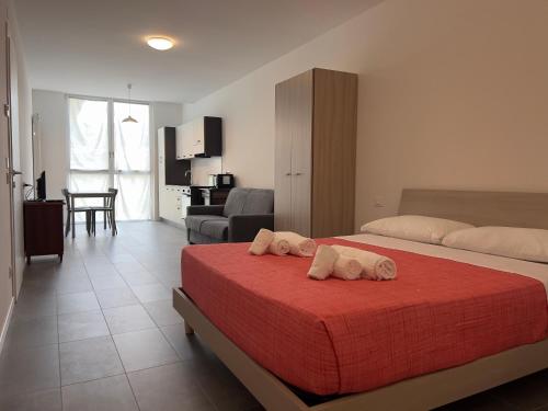 a bedroom with two beds and a living room at Quintarelli Home Europa 2 in Negrar