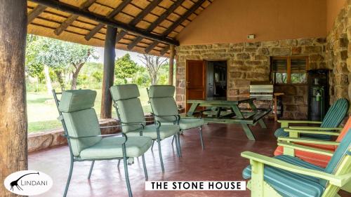 a group of chairs and a table on a porch at Lindani Game and Lodges in Vaalwater