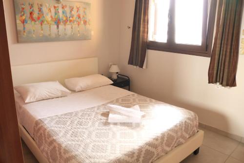 a bedroom with a bed with a towel on it at Großes Haus mit traumhaftem Ausblick in Georgioupolis
