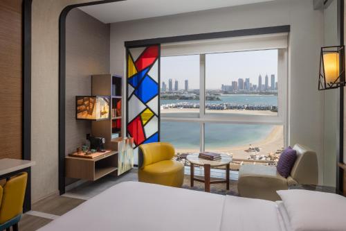 a bedroom with a large window with a view of the city at Andaz Dubai The Palm, By Hyatt in Dubai