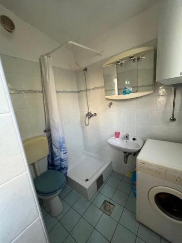 a small bathroom with a toilet and a sink at Home Vibe in Sukošan