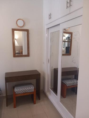 a dressing room with a mirror and a bench and a stool at Studio in the heart of El Gouna in Hurghada