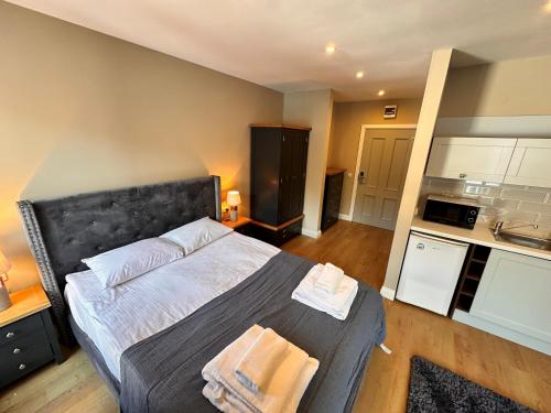 a bedroom with a bed with two towels on it at Predela 2 Aparthotel in Bansko