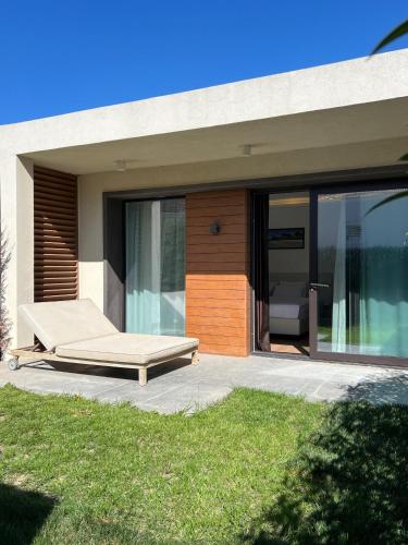a bed on a patio next to a house at Sea breeze White Villa 1 in Bilgah